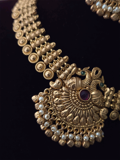 Broad chain with circular design with peacock design ruby,green stone center set