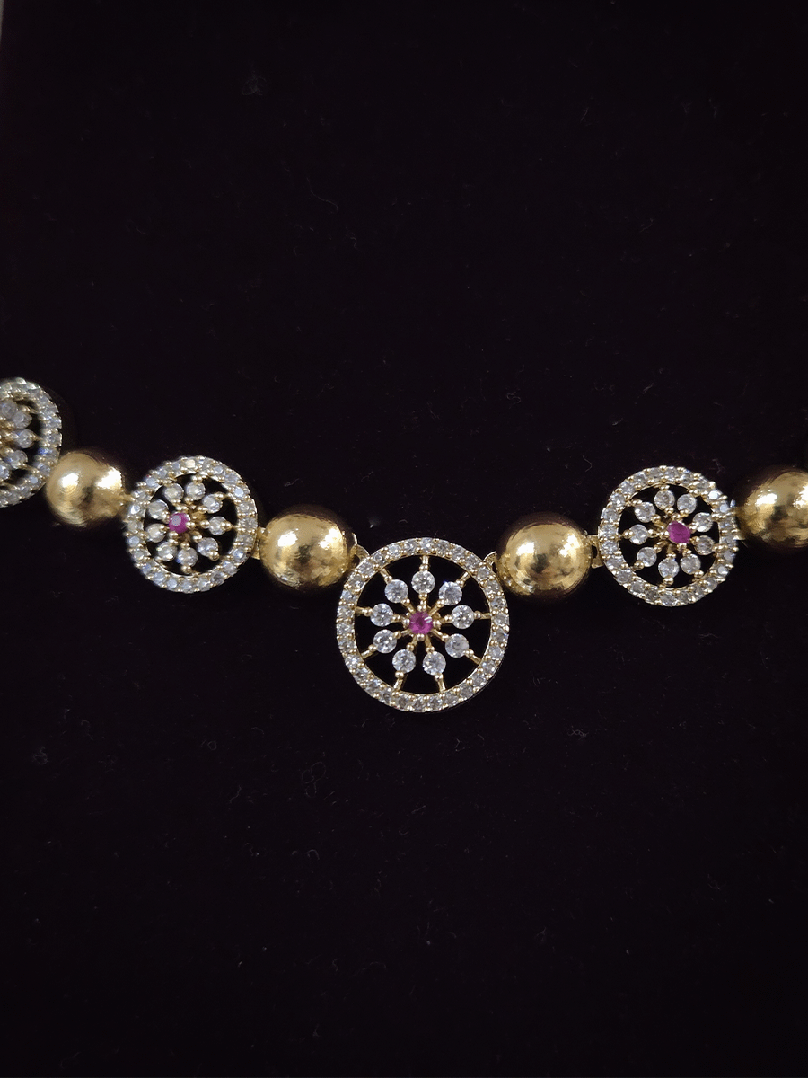 Circular zircon studded tukdies with half gold bead design sleek set