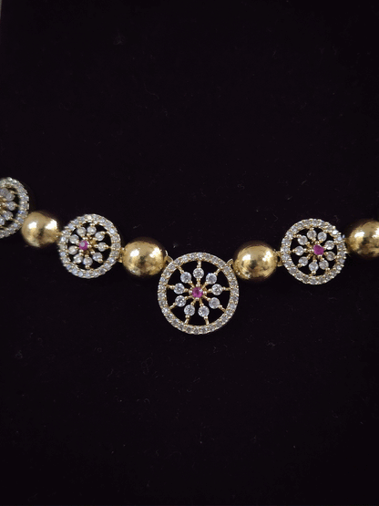 Circular zircon studded tukdies with half gold bead design sleek set