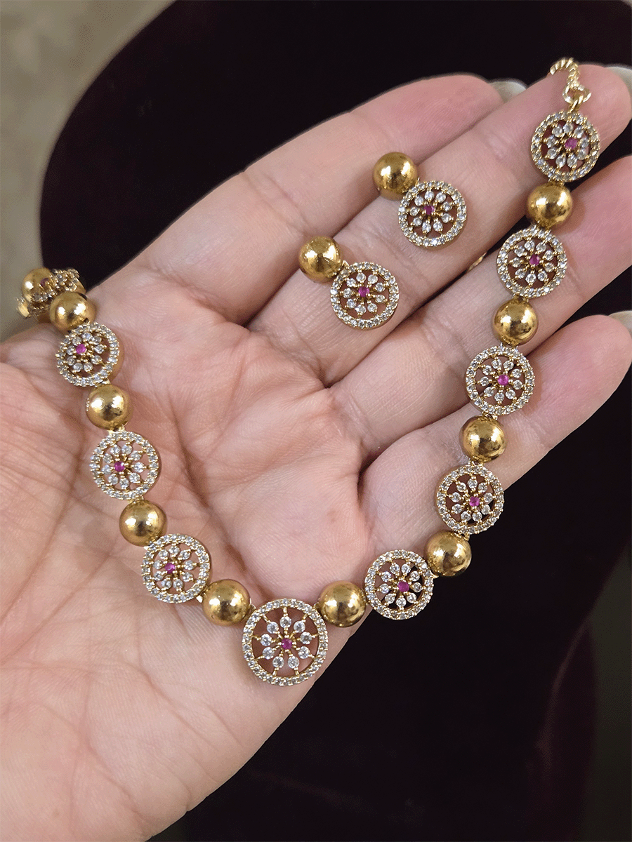 Circular zircon studded tukdies with half gold bead design sleek set