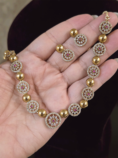 Circular zircon studded tukdies with half gold bead design sleek set