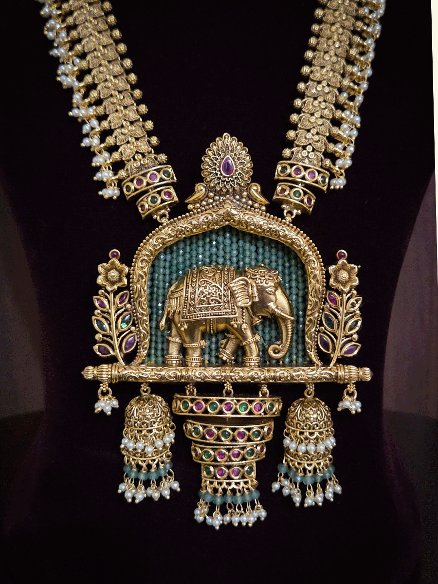 Broad chain with pearly hangings long elephant motif pendant set on aqua beads back