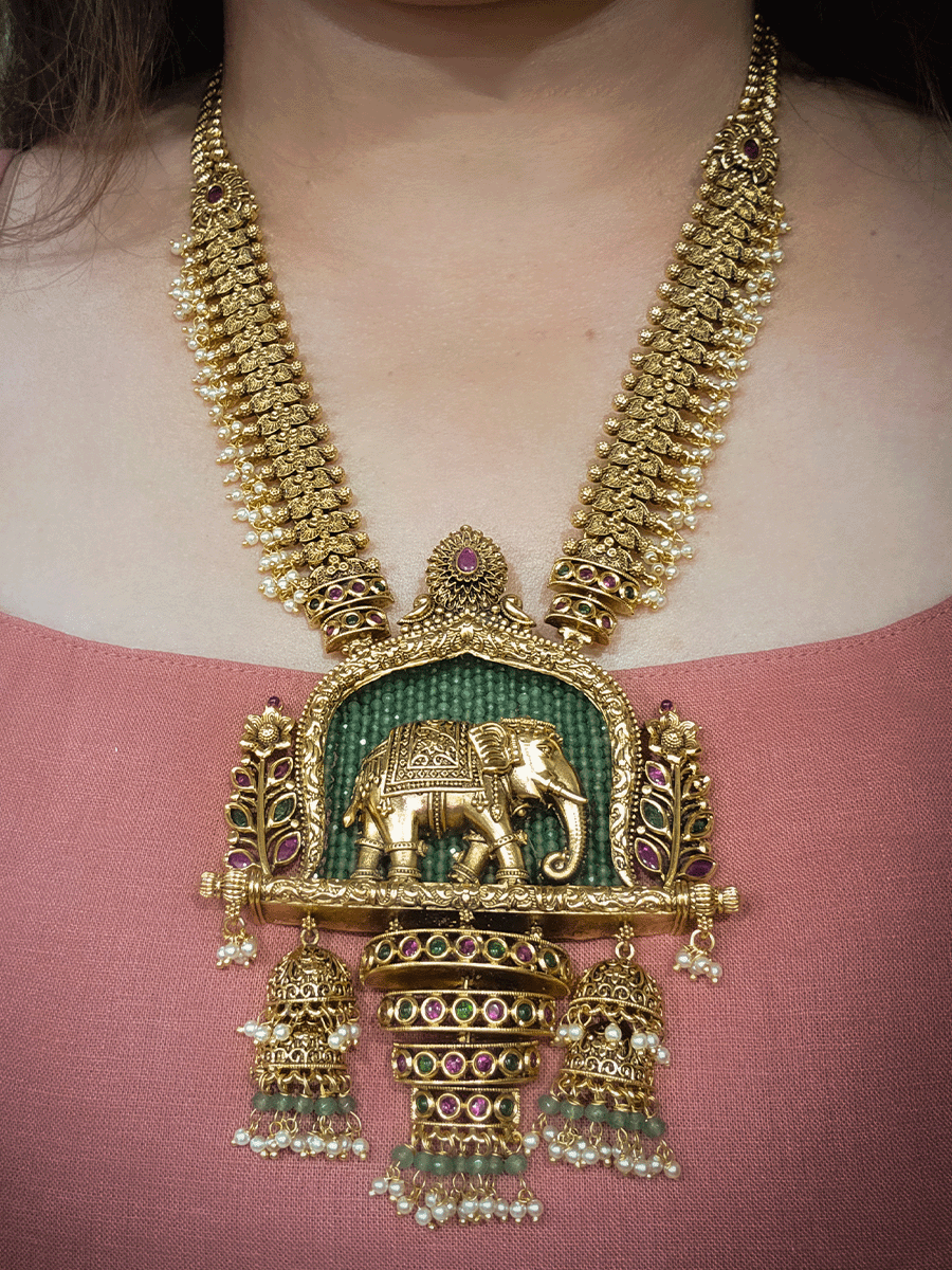 Broad chain with pearly hangings long elephant motif pendant set on aqua beads back