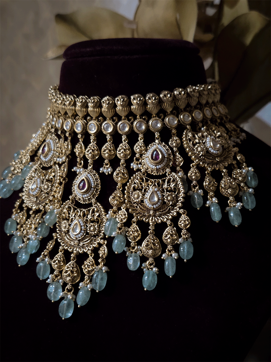 Traditional kundan set with chandbali design tukdies and leaf tassel hangings