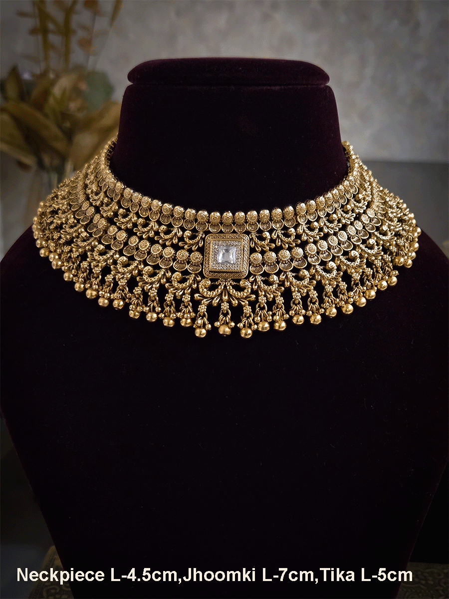 Gold bead lace on top of intricately carved choker set with square kundan in center