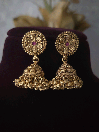 Three ruby stone flowers in circular design set with ghunghru hangings