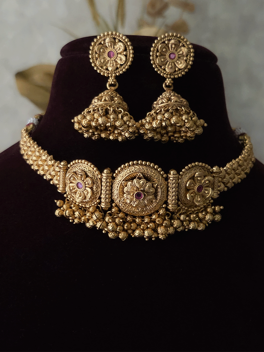 Three ruby stone flowers in circular design set with ghunghru hangings