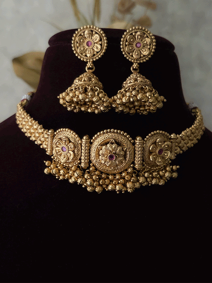 Three ruby stone flowers in circular design set with ghunghru hangings