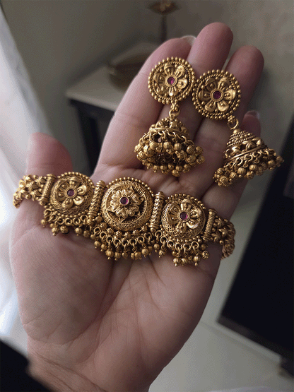 Three ruby stone flowers in circular design set with ghunghru hangings