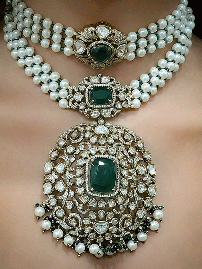 Set of two coloured stones polki studded mehandi finish neckpieces set with three pearl strings(one short and one bold pendant)