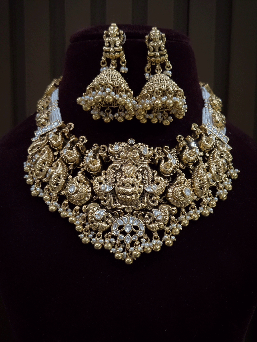 7 cm broad kundan studded laxmi ji choker set with intricately carved peacocks