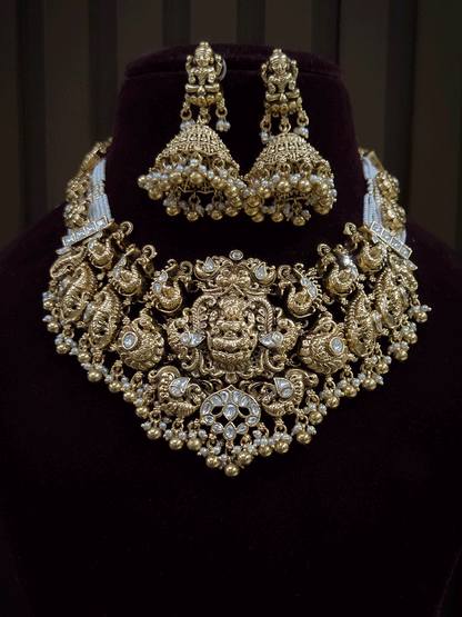 7 cm broad kundan studded laxmi ji choker set with intricately carved peacocks