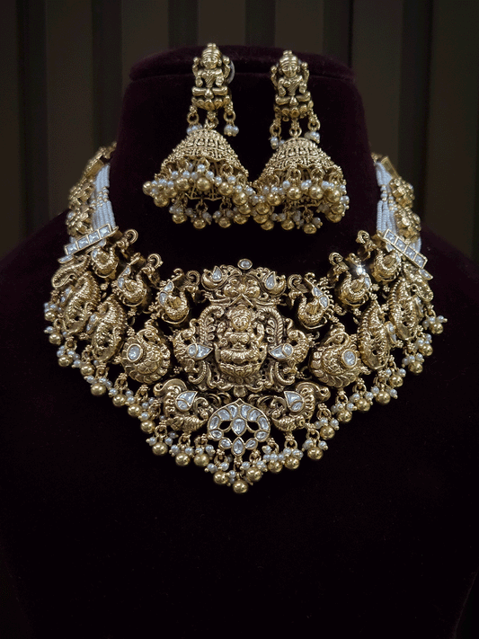7 cm broad kundan studded laxmi ji choker set with intricately carved peacocks