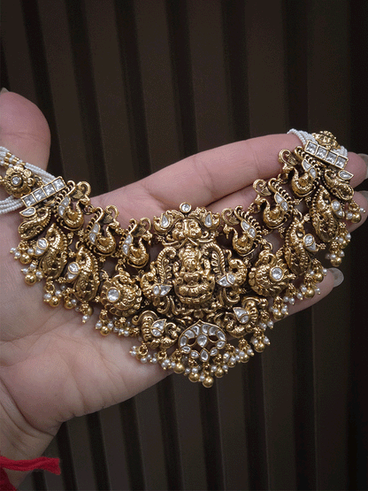 7 cm broad kundan studded laxmi ji choker set with intricately carved peacocks