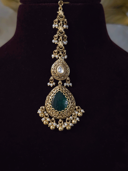 Antique gold finish kundan set with bold tear drop shaped stone in center