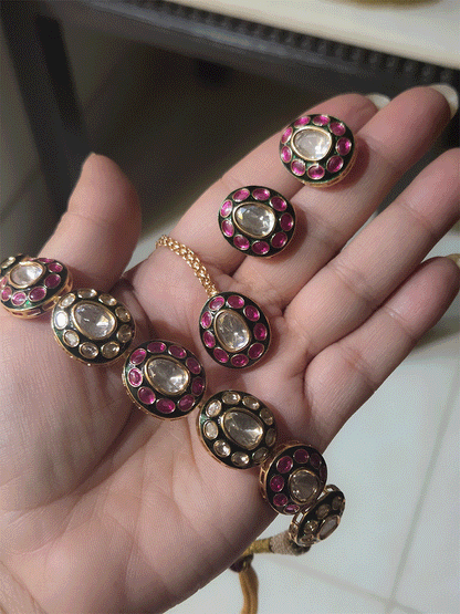 Ruby stones and kundan studded oval green enamel connecting tukdies set