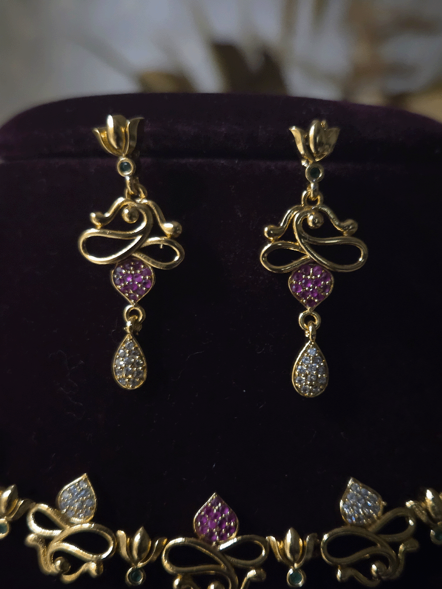 Lotus flower design sleek set with stones studded leaves and tear shaped white stones drop in center