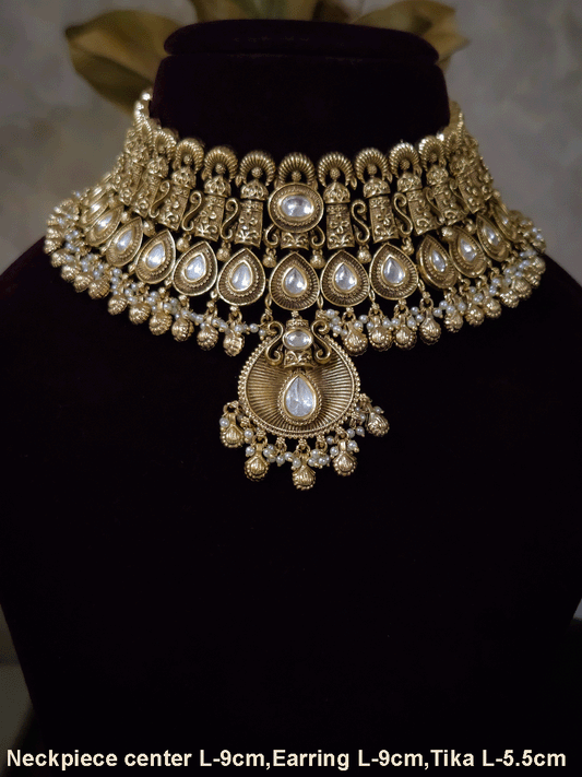 Oval kundan in center of shell ghunghru hangings intricately carved choker set with tear shaped kundan line