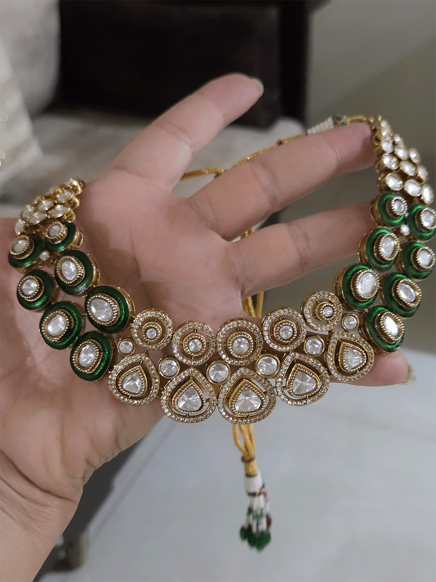 Uncut polki and moissanite studded classy set with green enamel detailing on both sides