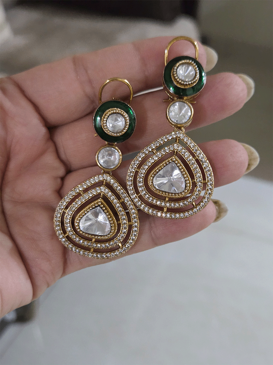Uncut polki and moissanite studded classy set with green enamel detailing on both sides