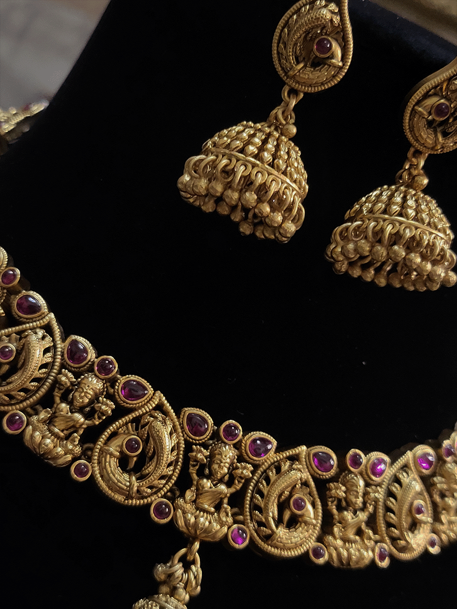 Laxmiji and peacock motif's ruby stones studded set with gold bead drop in center