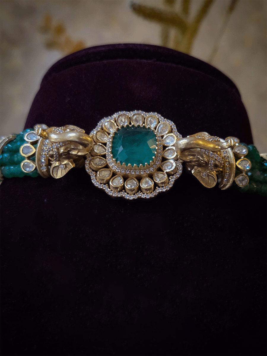 Elephant faces on sides of coloured stone in center of moissanite tukdi four bead strings set