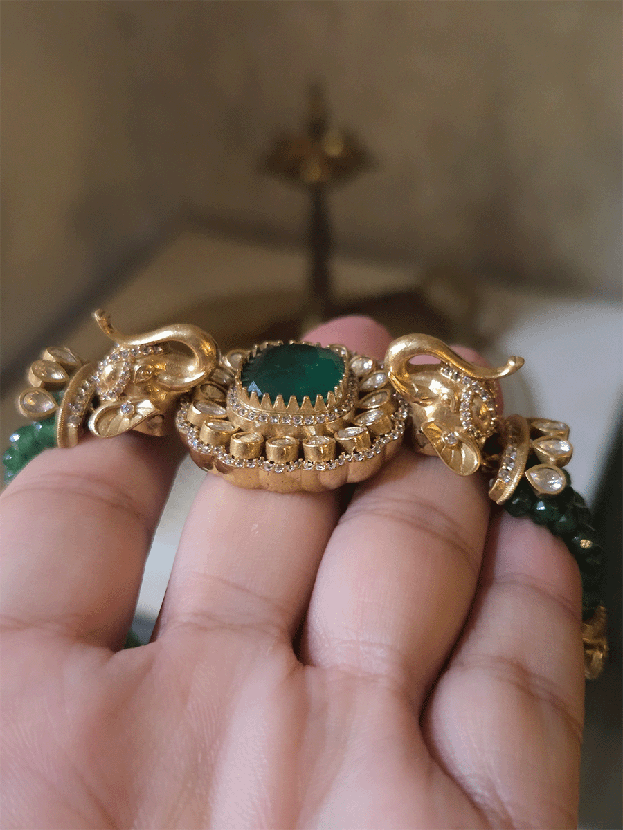 Elephant faces on sides of coloured stone in center of moissanite tukdi four bead strings set