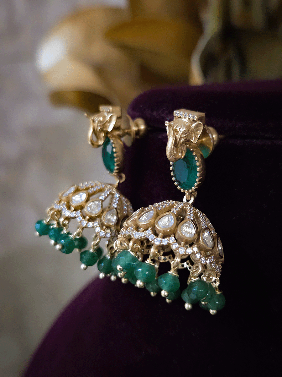Elephant faces on sides of coloured stone in center of moissanite tukdi four bead strings set
