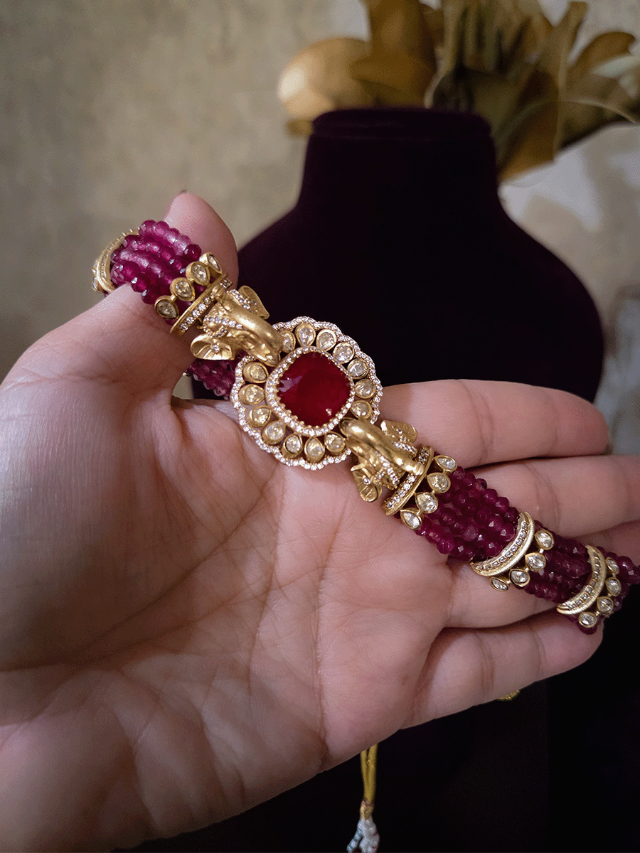Elephant faces on sides of coloured stone in center of moissanite tukdi four bead strings set
