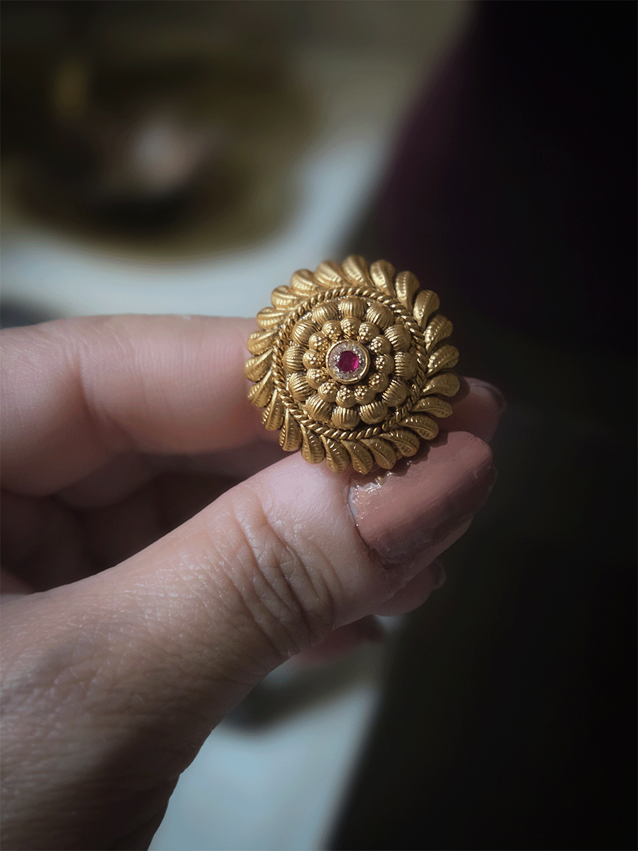 Circular gold bead design with ruby stone center adjustable ring