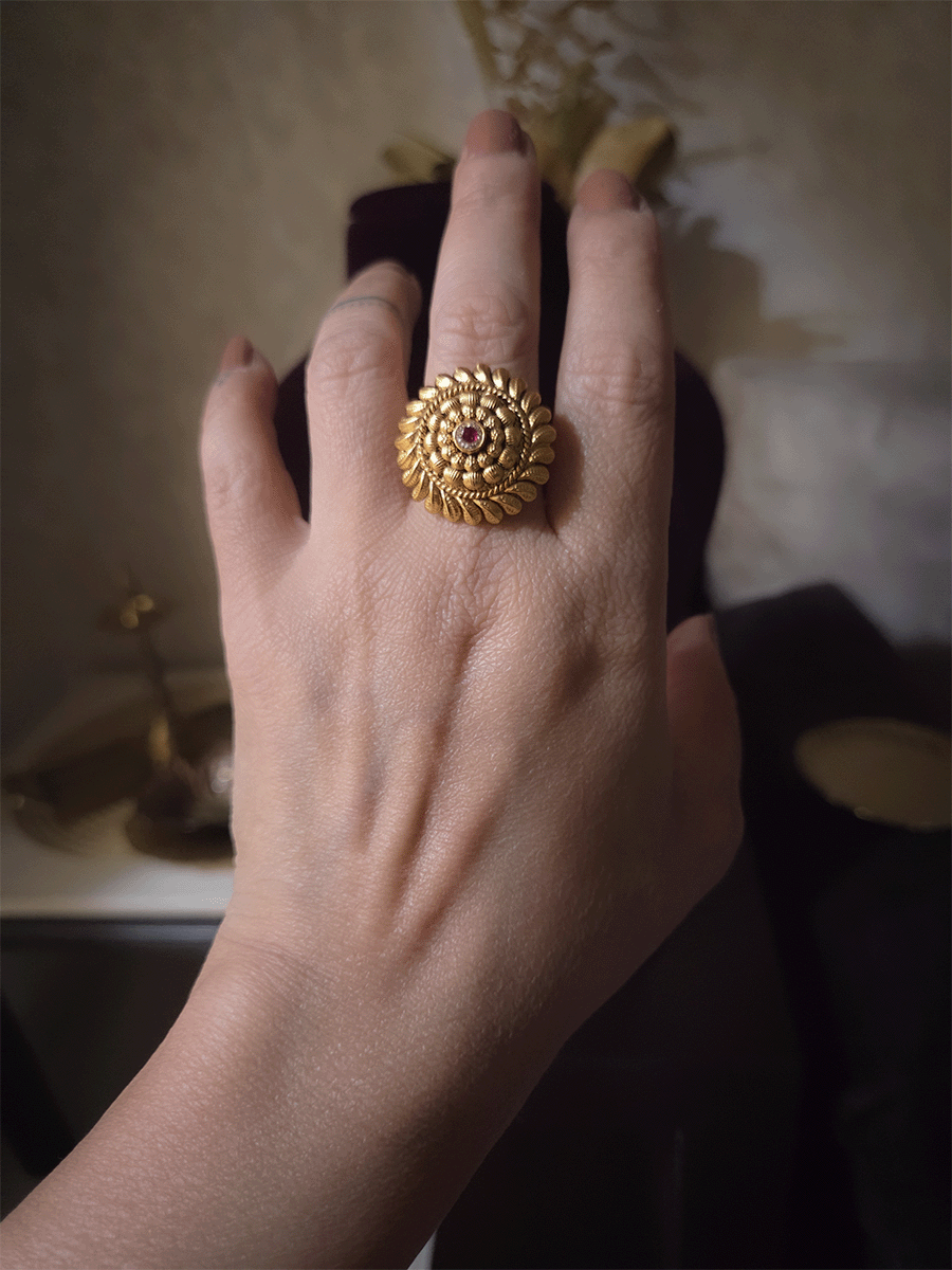 Circular gold bead design with ruby stone center adjustable ring