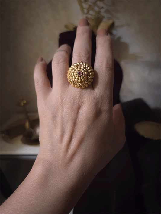 Circular gold bead design with ruby stone center adjustable ring