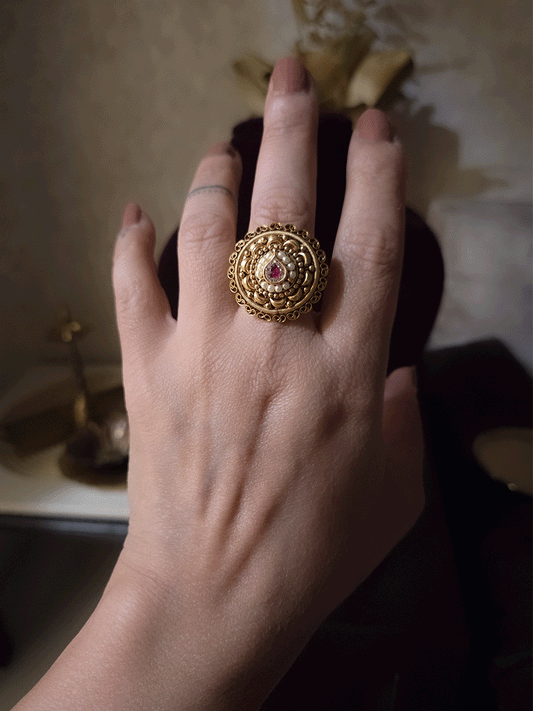 Circular adjustable ring with tear drop ruby stone center