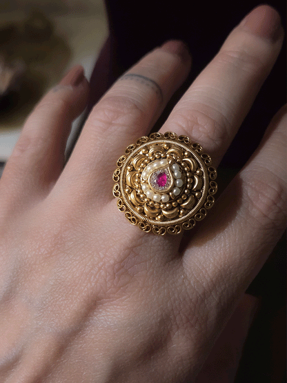 Circular adjustable ring with tear drop ruby stone center