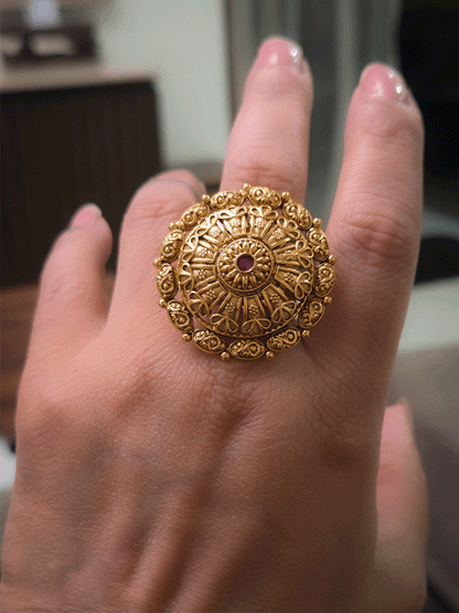 Flower design bold adjustable ring with ruby stone center and oval design outline