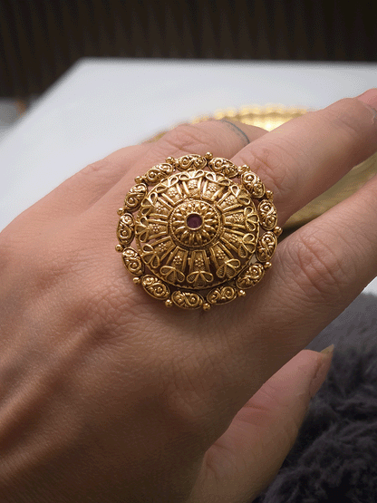 Flower design bold adjustable ring with ruby stone center and oval design outline