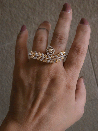 Gold and silver finish zircon studded long leaf on one end and circular on other end of openable ring
