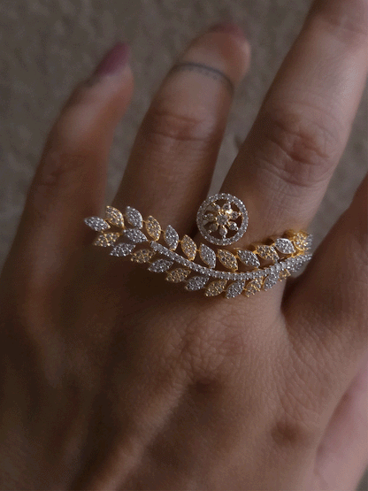 Gold and silver finish zircon studded long leaf on one end and circular on other end of openable ring