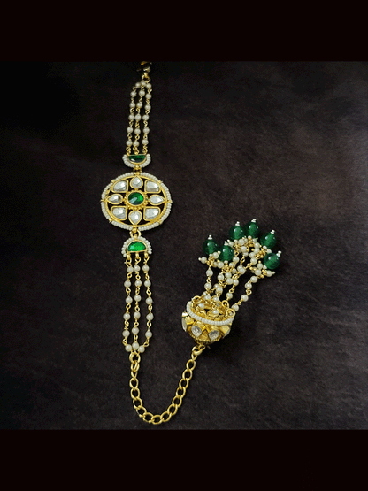 Coloured stone in the center of round paachi kundan bhabhi or sister rakhi with jhoomki tassel