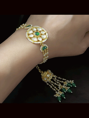 Coloured stone in the center of round paachi kundan bhabhi or sister rakhi with jhoomki tassel