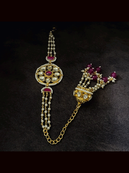 Coloured stone in the center of round paachi kundan bhabhi or sister rakhi with jhoomki tassel