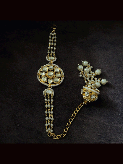 Coloured stone in the center of round paachi kundan bhabhi or sister rakhi with jhoomki tassel