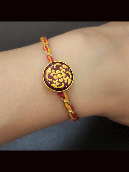 Round maroon and green stone(1.75cm) gold work mauli thread rakhi