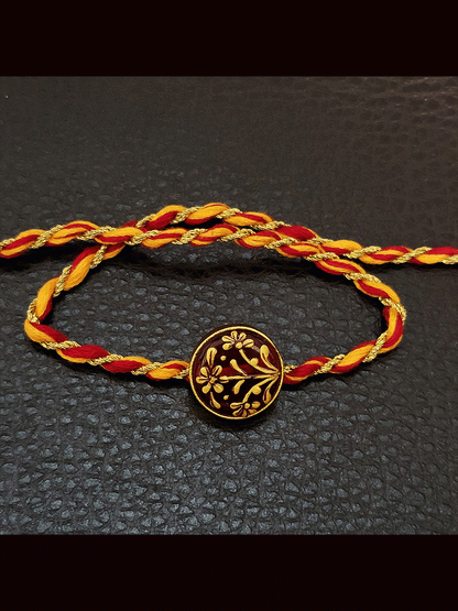 Round maroon and green stone(1.75cm) gold work mauli thread rakhi