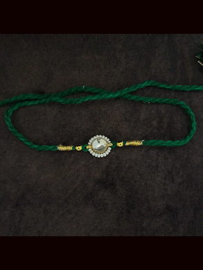 Round stone pirohi work rakhi with two gold beads on sides