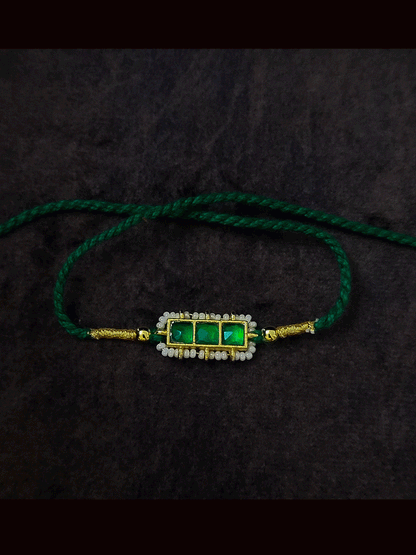 Three paachi kundan pirohi work coloured stones and coloured thread rakhi