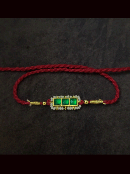 Three paachi kundan pirohi work coloured stones and coloured thread rakhi