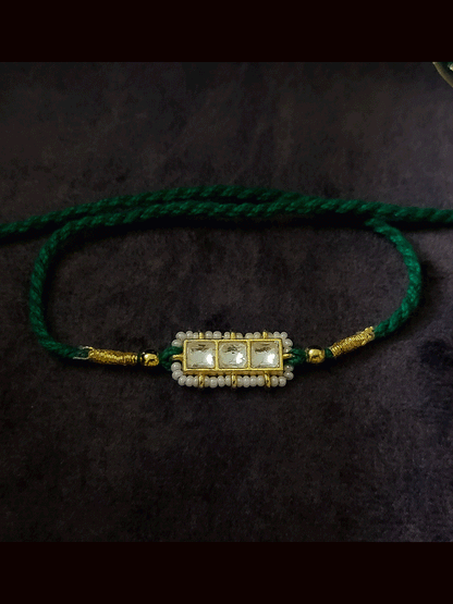 Three paachi kundan pirohi work coloured stones and coloured thread rakhi