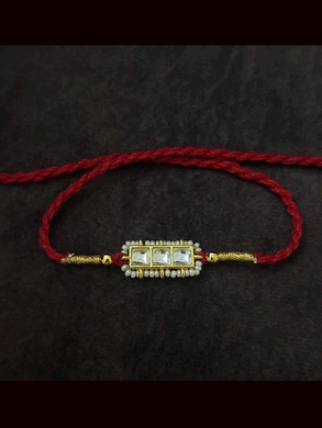 Three paachi kundan pirohi work coloured stones and coloured thread rakhi