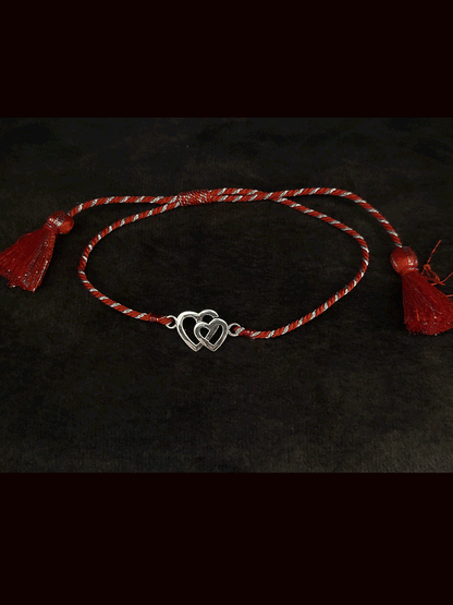 Sterling silver heart on heart pull on red thread rakhi